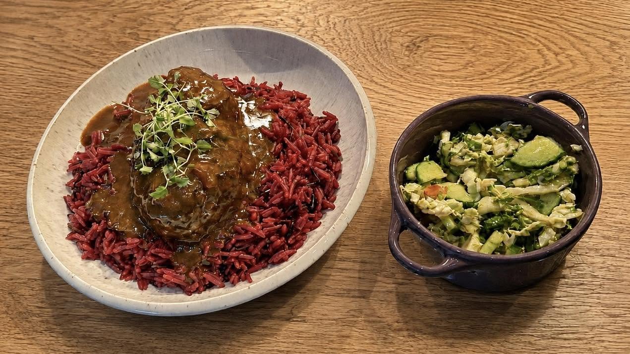 Twisted Willow's complete plate of slow-cooked beef and beetroot rice, with a whole bowl of Cypriot village salad